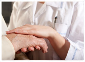 gerontology nurse holding elderly hand