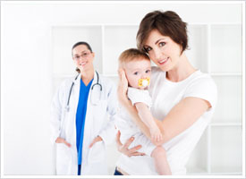 pediatric nurse standing with mother and child