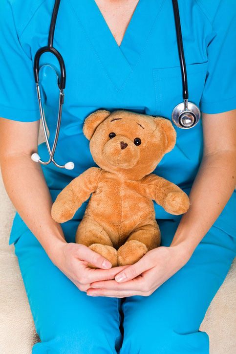 pediatric nurse holding teddy bear