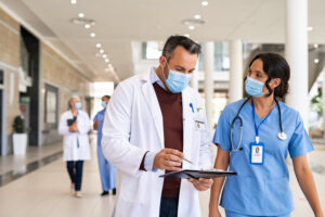 Nurse practitioner speaking with colleague