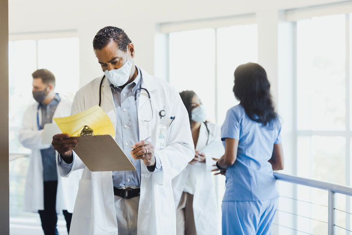 nurse reading clipboard